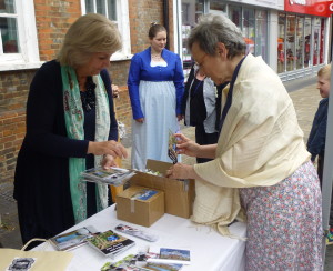 Jane Odiwe and Susan Mason Milks putting together bags of bookmarks and post cards