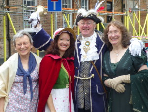 Susan Mason-Milks, Maria Grace and Abigail Reynolds with the town crier