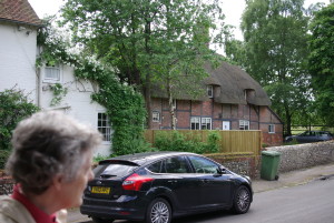 Jane Hurst giving the history of the thatched cottage in the background.
