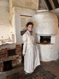My daughter wearing Regency dress in the bakehouse at Chawton Cottage